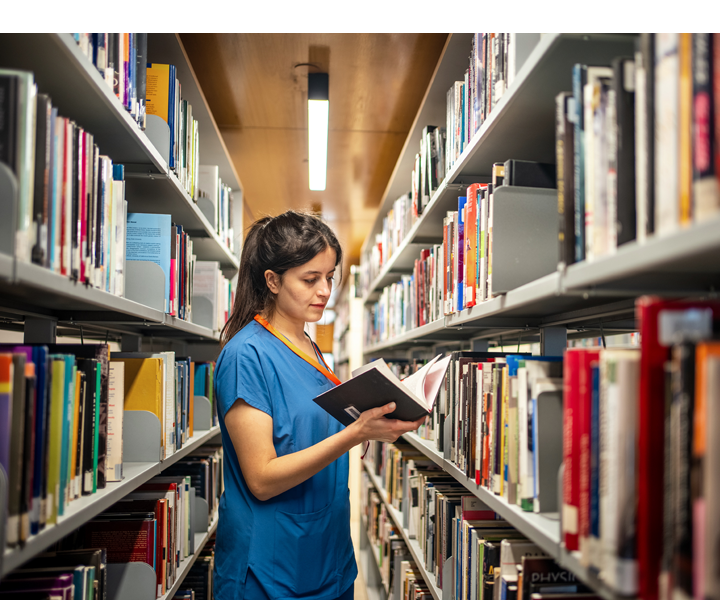 female intern doing research in the library to study